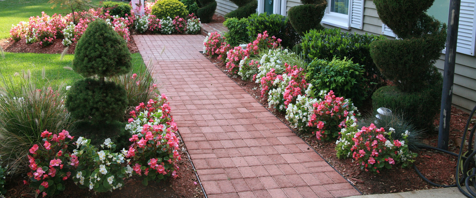 brick walkway with flowers
